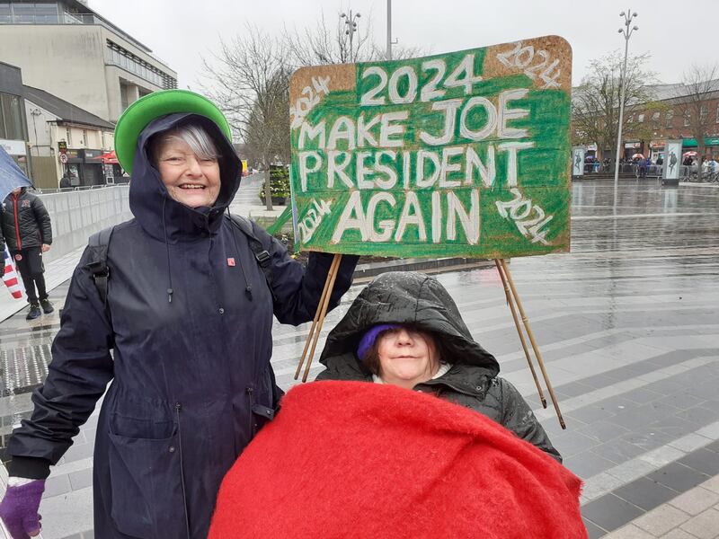 Christine Larkin and Geraldine Lavin brave the weather to catch a glimpse of Joe Biden in Dundalk. Photograph: Conor Capplis