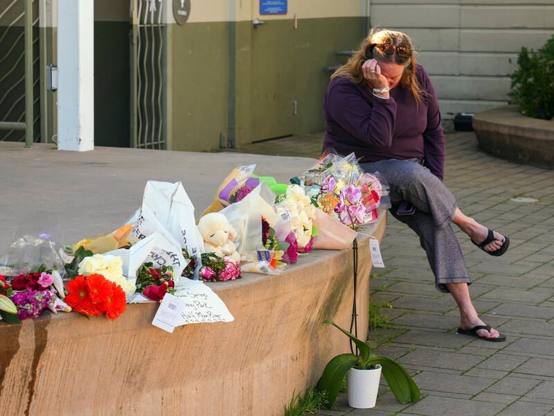 Elisabeth Olander  at a makeshift memorial for the seven victims of a mass shooting at a mushroom farm and three more nearby at an agricultural nursery, in Half Moon Bay, California in January. on Wednesday, Jan. 25, 2023. Photograph: Jim Wilson/New York Times