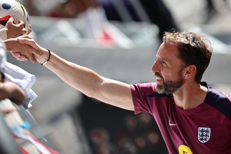 Gareth Southgate shakes hand with a fan after a training session of the English national soccer team in Jena, Germany. Photograph: Anna Szilagyi/EPA