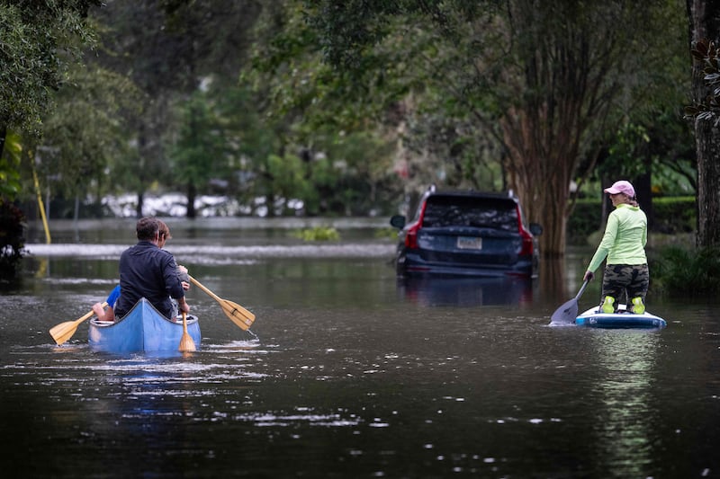 People canoe and paddle board on a flooded street in the aftermath of Hurricane Ian in Orlando, Florida. Photograph: Jim Watson/AFP