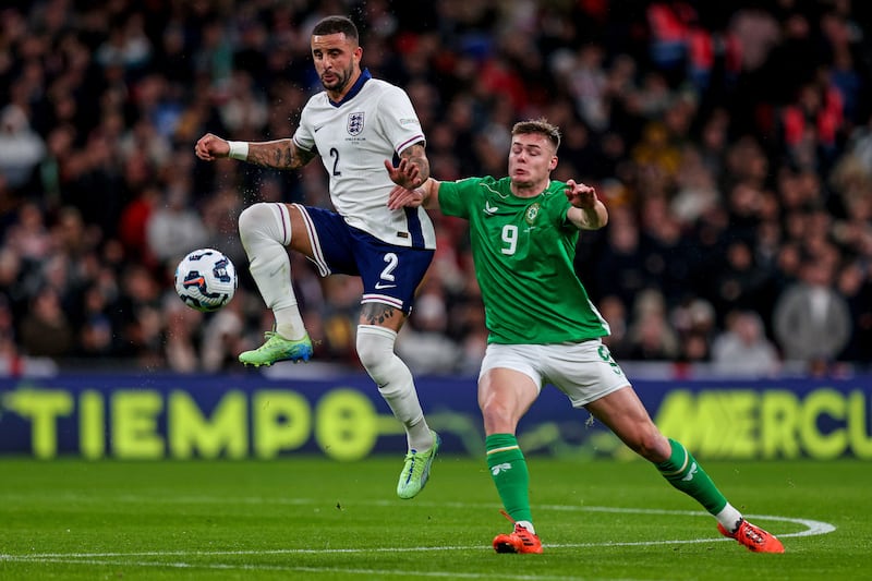 England's Kyle Walker is challenged by Ireland's Evan Ferguson. Photograph: Ryan Byrne/Inpho