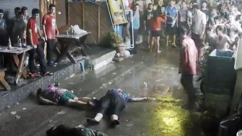 A still image from a CCTV video shows British man Lewis Owen and his parents  on the ground after they were  attacked during a family vacation in Thailand. Photograph: AP