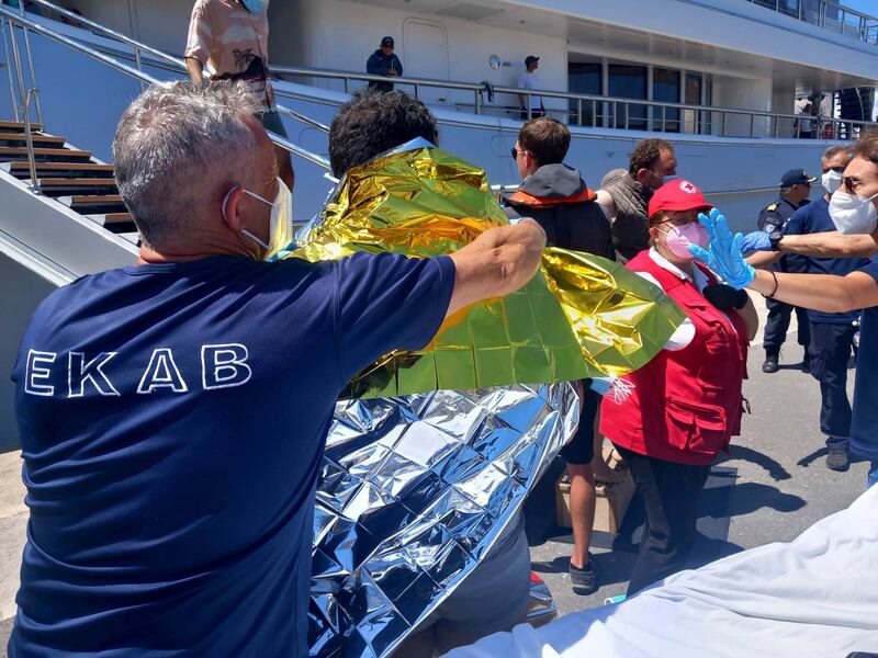 Survivors receive first aid after the rescue operation. Photograph: argolikeseidhseis.gr/AP