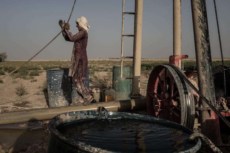 A well-drilling crew searches for water on a farm in Shagai, in southwest Afghanistan’s arid Bakwa district on August 16th, 2023. Solar-powered water pumps fuelled a boom in narcotics crops in the Bakwa, though the use of private reservoirs — an incredibly wasteful method of irrigation due to quick evaporation in the desert heat — has left the water quickly running out. Photograph: Bryan Denton/The New York Times
                      