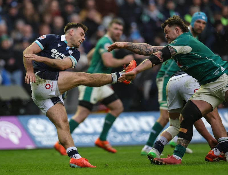 Scotland's Ben White is charged down by Ireland's Andrew Porter. Photograph: Billy Stickland/Inpho