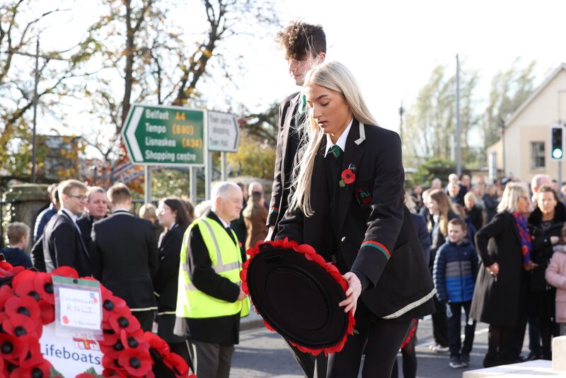 Elise Breen from Erne Integrated School lays a wreath during the Remembrance Sunday service at the Cenotaph in Enniskillen. Photograph: PA