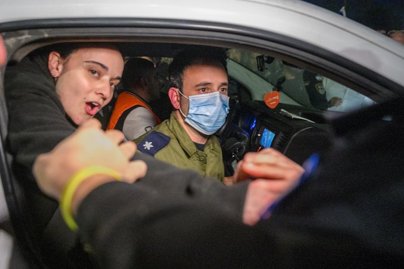 Friends reach out to British-Israeli hostage Emily Damari as she arrived on Sunday at Sheba Medical Center, where hostages arrived after the first phase of a ceasefire agreement began between Israel and Hamas, in Ramat Gan, Israel. Photograph: Alexi J Rosenfeld/Getty Images