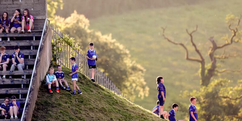 Young fans let their attention wander during the Cavan v Dublin clash at  Kingspan Breffni Park. Photograph: James Crombie/Inpho 