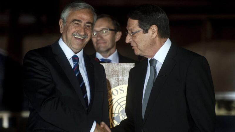 Cypriot president Nicos Anastasiades (right) shakes the hand of Turkish Cypriot president of the self-proclaimed Turkish Republic of Northern Cyprus (TRNC), Mustafa Akinci (left), as special adviser to the UN secretary general on Cyprus, Norwegian Espen Barth Eide (centre) looks on. Photograph: Iakovos Hatzistavrouiakos/AFP/Getty Images