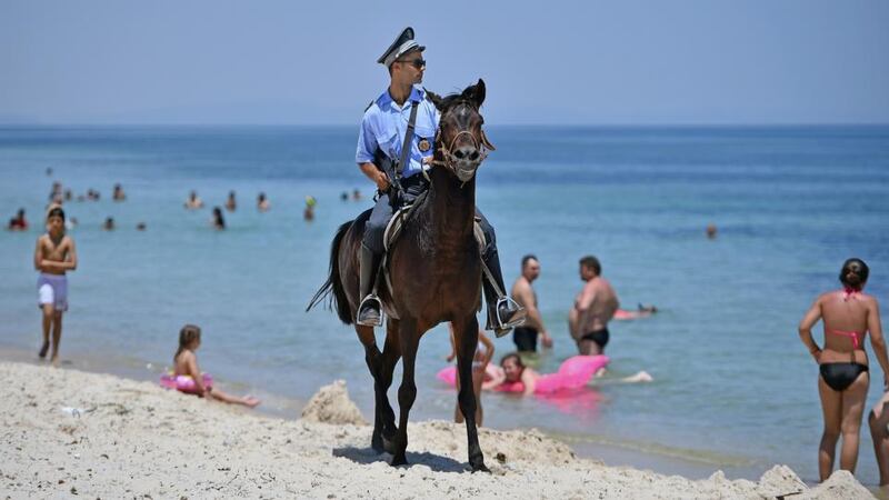 An armed police officer on horseback patrolling  Marhaba beach, Sousse, Tunisia,  on June 28th, 2015.  Photograph: Jeff J Mitchell/Getty Images