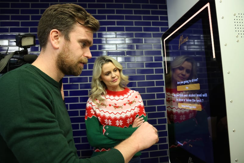 Actors using a Flinebox, an interactive breathalyser terminal that can be located in hotels and other public areas. Photograph: Bryan O’Brien
