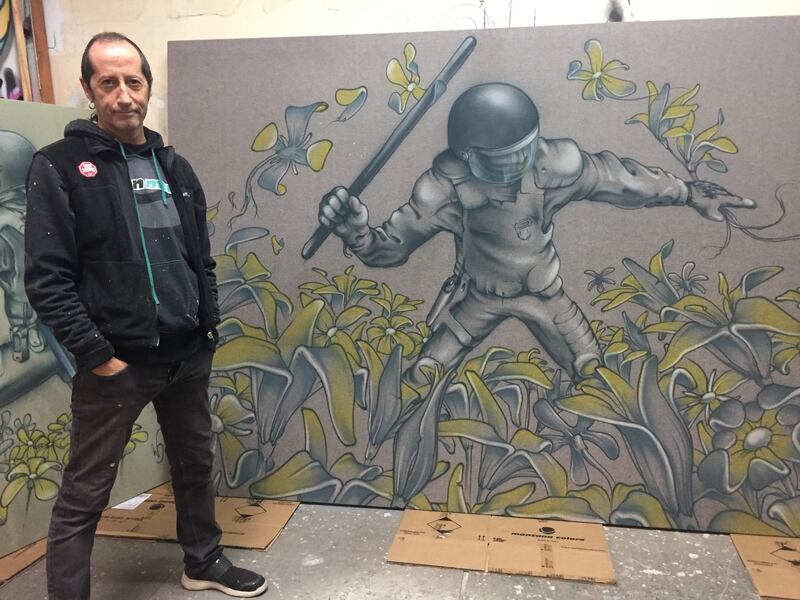 The Catalan street artist known as Werens with one of the works from his new exhibition. Photograph: Guy Hedgecoe