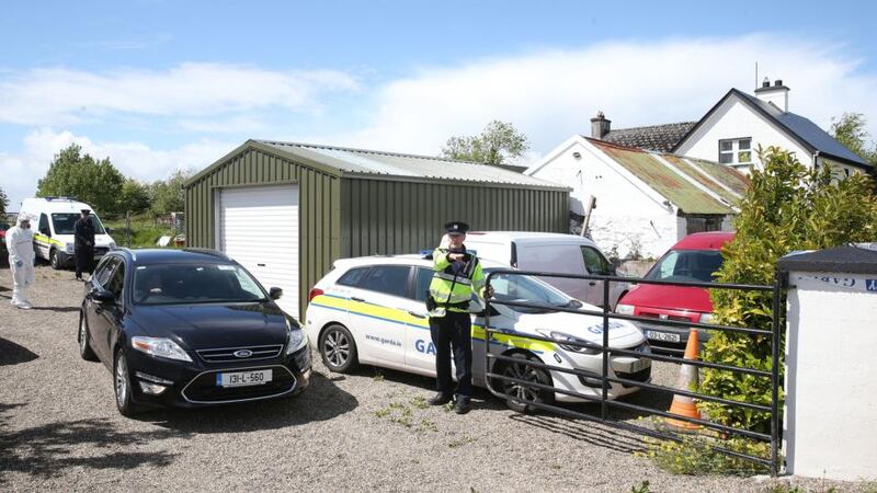 Garda at a farmhouse in the townland of Boolaglass, between Rathkeale and Askeaton in Co Limerick, where a couple where found dead on May 18th, 2015.  Photograph: Brian Lawless/PA Wire