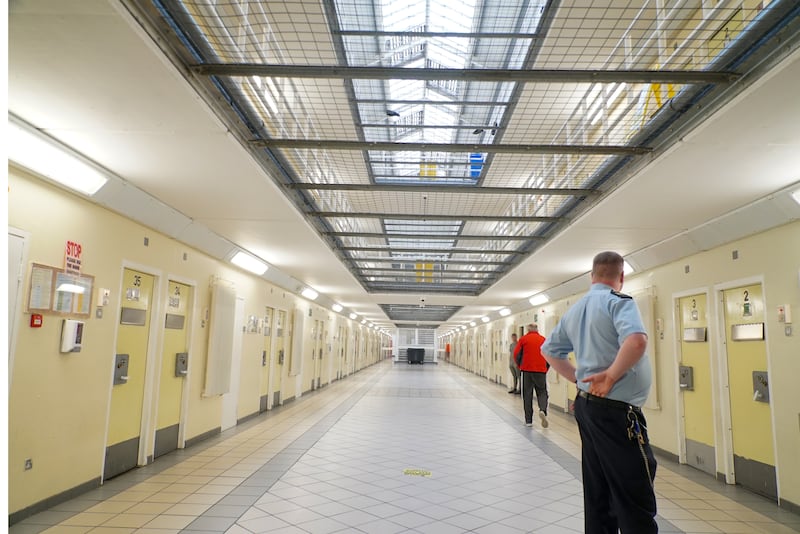 A prison officer monitors two prisoners in a wing of the Midlands Prison. Photograph: Enda O'Dowd