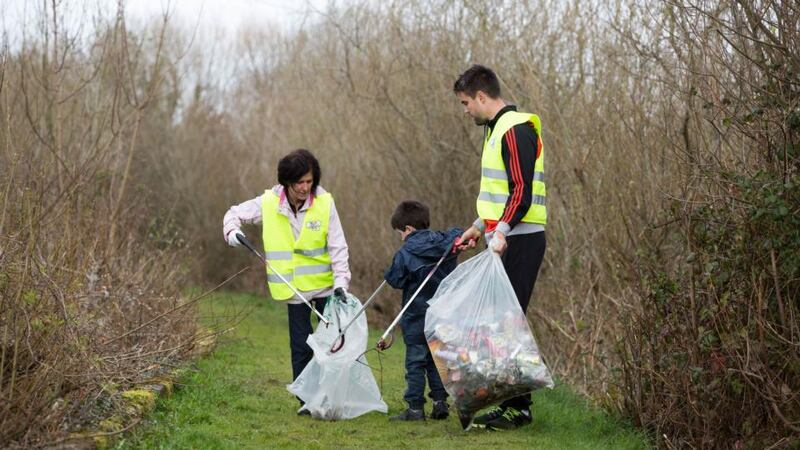 Conor Murray with  Limerick clean-up volunteers Lucy and Cian Gibbons near Grove Island, Corbally, Limerick. Photograph: FusionShooters