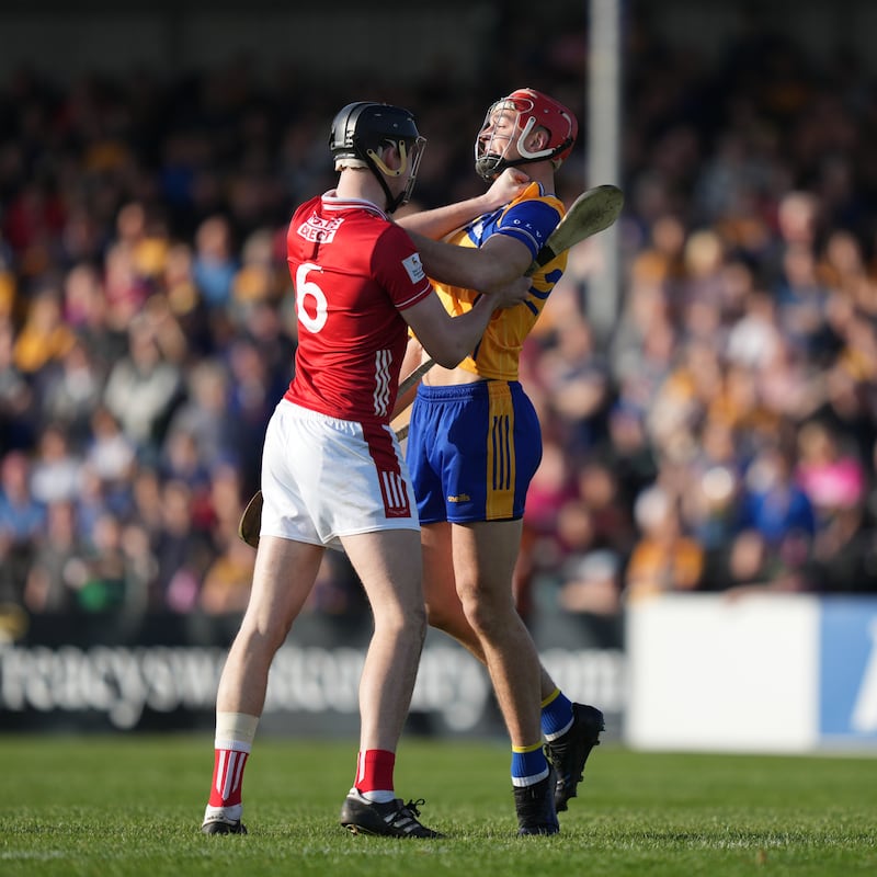 Robert Downey of Cork and Peter Duggan of Clare clash in Páirc Chiosog, Ennis on Sunday. Photograph: James Lawlor/Inpho