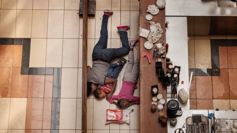 Second Prize Spot News by Tyler Hicks of the US, for the New York Times, September 21st, 2013, in Nairobi, Kenya. A woman and children hiding in the Westgate mall after gunmen opened fire. At least 39 people were killed but the three pictured escaped unharmed.