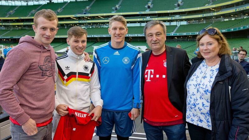 Peter Fitzpatrick, Alexei Schuster, John Schuster and Graziella Schuster meet German footballer Bastian Schweinsteiger during a German training session at the  Aviva Stadium. Photograph: Morgan Treacy/Inpho