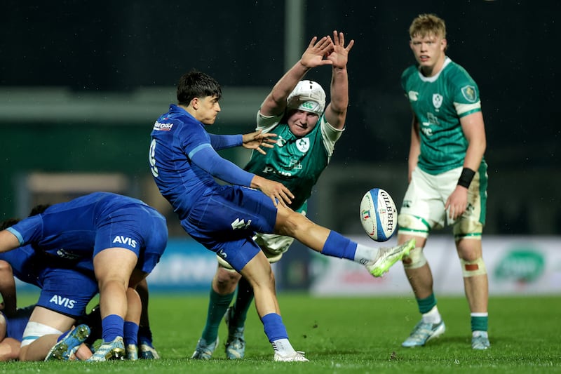 Ireland captain Éanna McCarthy attempts to block a kick by Italy's Niccolò Beni. Photograph: Laszlo Geczo/Inpho