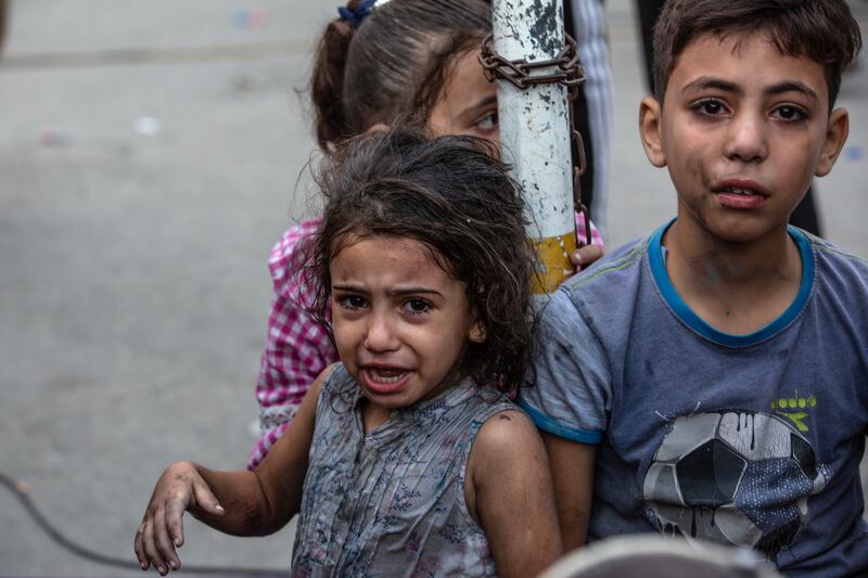 A girl whose home was hit by an Israeli air strike on Tuesday arrives at the Al-Shifa Hospital in Gaza City. Photograph: Samar Abu Elouf/New York Times