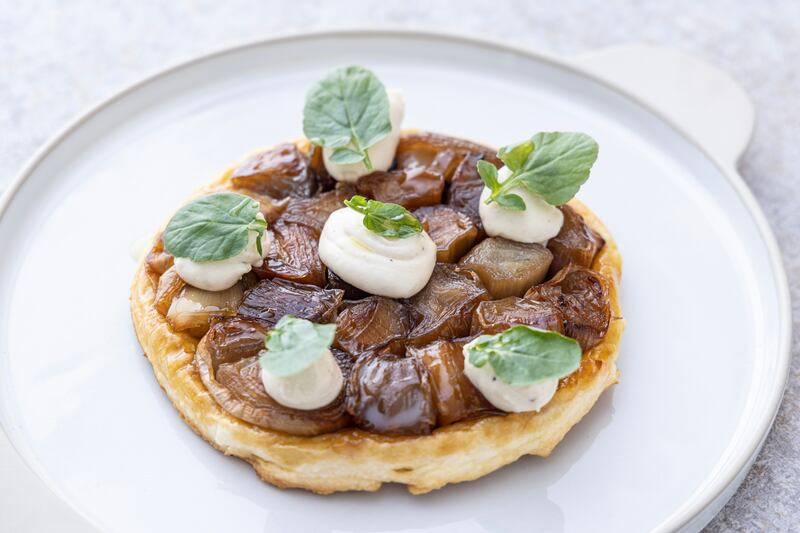 Caramelised shallot tart Tatin with roasted garlic and whipped goat’s cheese. Photograph: Harry Weir