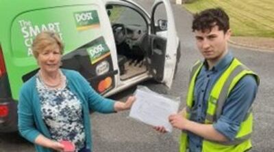 Anne Mooney takes delivery of The Irish Times from the postman. Photograph: Michael Mooney