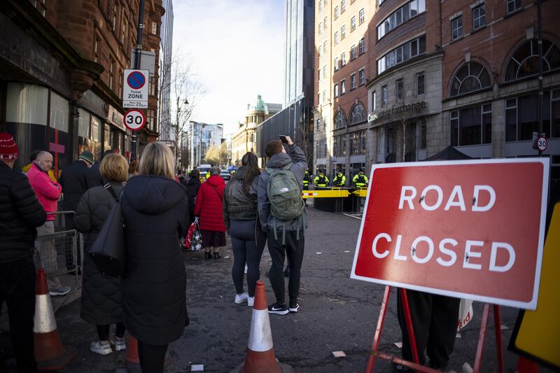 People wait outside Belfast's Grand Central Hotel ahead of US president Joe Biden's meeting with UK prime minister Rishi Sunak. Photograph: Tolga Akmen