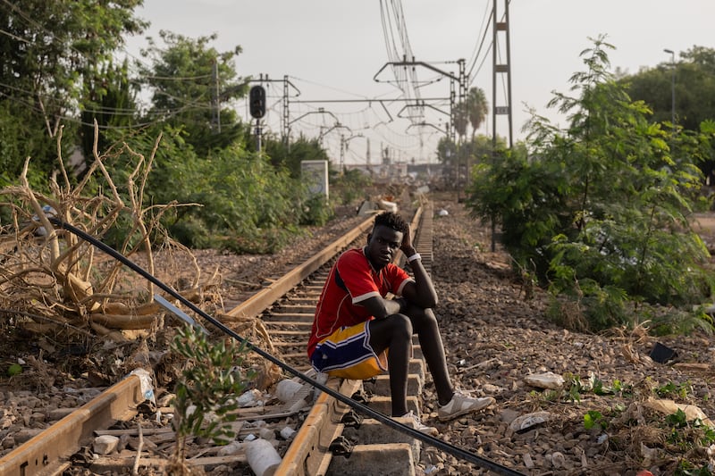 A man sits on a train track after the flooding in the Paiporta municipality of Valencia. Photograph: David Ramos/Getty Images