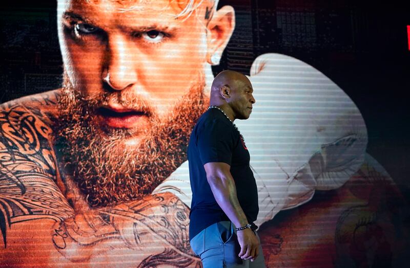 Mike Tyson, now touching 60, will face US YouTuber Jake Paul (background) in Arlington, Texas. Boxing has always been a fecund space for money men peddling freak shows to easily part fools from their money. Photograph: Timothy A Clary/AFP/Getty Images