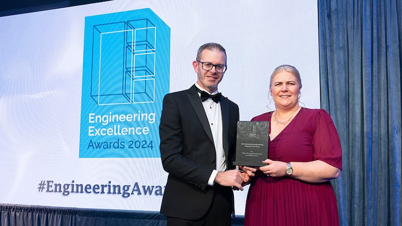 Niall Hanley, awards judge, presents the environmental engineering project of the year award to Allison Murphy, Tobin