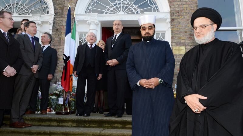 The scene during the minute’s silence at the French Embassy in Dublin where the Presient Micheal D Higgins and his wife Sabina were among the crowd gathered to honour  those who died and were injured in the Paris attacks. Photograph: Cyril Byrne