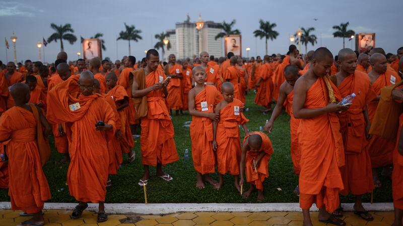 Monks checking their phones after a prayer ceremony during which the ashes of late King Norodom Sihanouk were interred in July 2014 at the Royal Palace in Phnom Penh. Photograph: Lauren Crothers