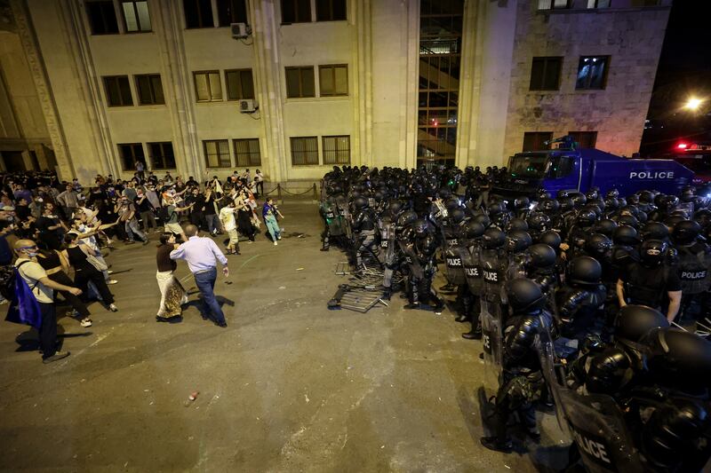 Riot police disperse protesters outside the Georgian parliament on Tuesday. Photograph: Giorgi Arjevanidze/AFP via Getty