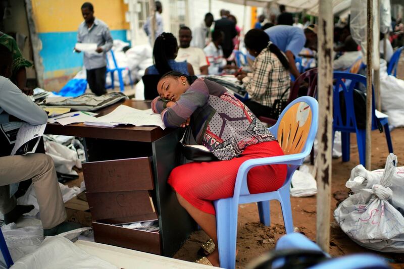 An exhausted  electoral commission official rests as results are tallied for the presidential election, at a local results compilation center in Kinshasa on January 6th Photograph: Jerome Delay/AP