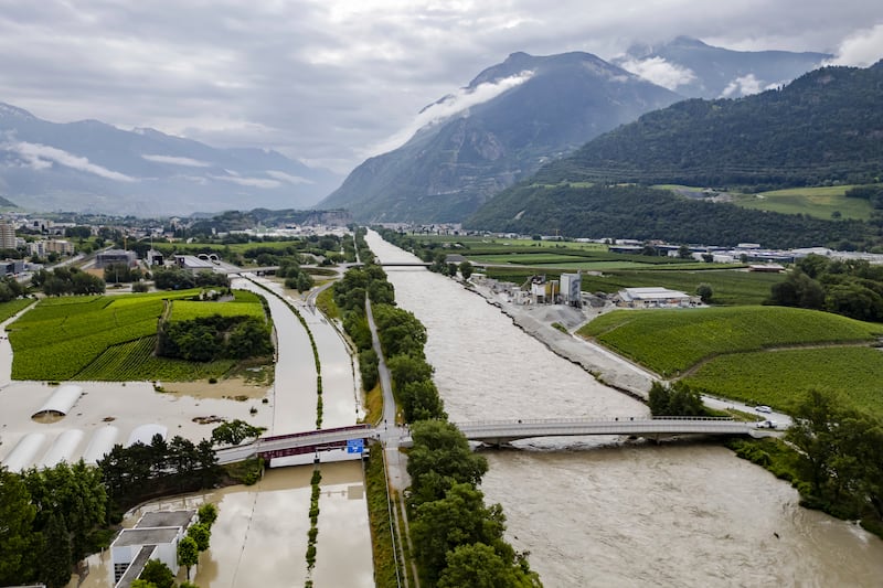 The Rhone river overflows in Sierre, Switzerland. Photograph: Jean-Christophe Bott/Keystone/AP