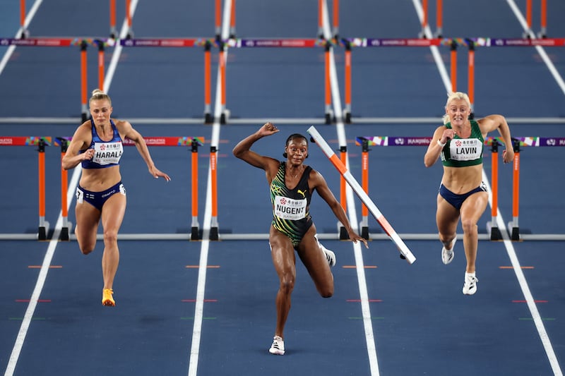 Ackera Nugent of Jamaica (C) knocks down a hurdle and sends it flying into the path of Ireland's Sarah Lavin. Photograph:  Cameron Spencer/Getty Images