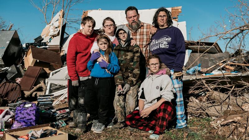 Lacy Duke (third from left) stands with her family in front of the rubble that was once their home in Dawson Springs, Kentucky. Photograph: William Widmer/New York Times