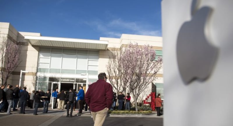 Attendees arrive at the Apple Inc. shareholders meeting at the company's headquarters in Cupertino, California, last month. The company has held talks with Beats Electronics on a potential partnership.