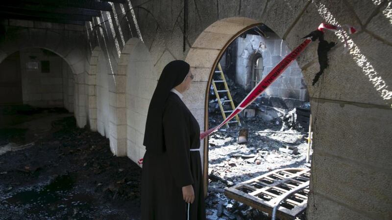 A nun looks at damage caused by a fire in the Church of Loaves and Fishes on the shores of the Sea of Galilee in northern Israel on  June 18th. Photograph: Baz Ratner/Reuters