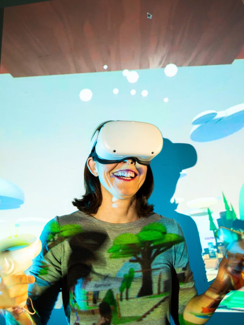 Kashmir Hill, a technology reporter for The New York Times, dons a Quest 2 headset to spend time in Horizon Worlds, Meta’s virtual reality-based social network. Photograph: Brian Finke/The New York Times