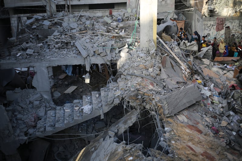 Palestinians look at the destruction after an Israeli strike in Rafah, Gaza Strip. Photograph: Hatem Ali/AP