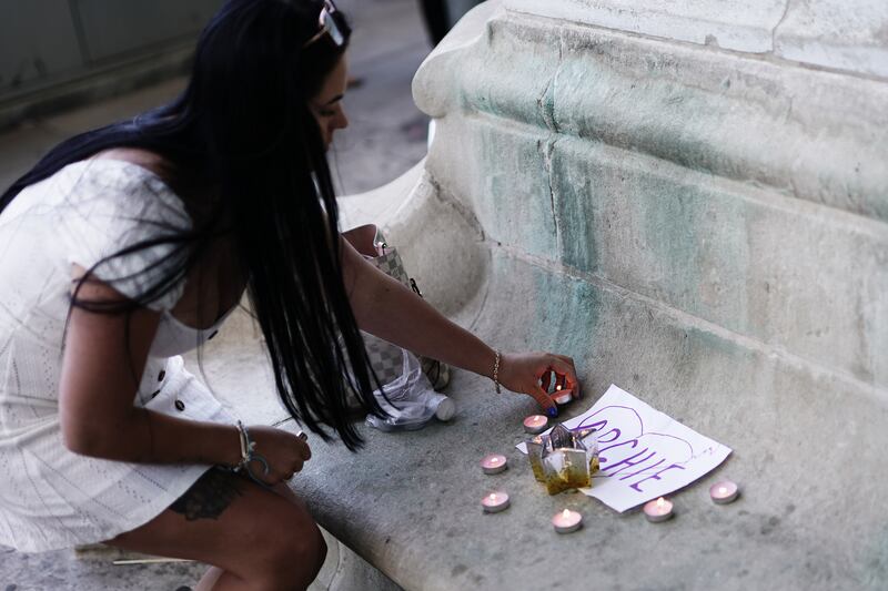 A person lights candles outside the Royal London hospital in Whitechapel, east London, following the death of Archie Battersbee. Photograph: Aaron Chown/PA