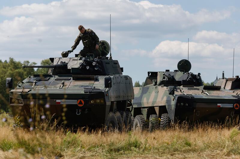 A Polish serviceman sits on an armoured vehicle in Jarylowka. Photograph: Michal Dyjuk/AP