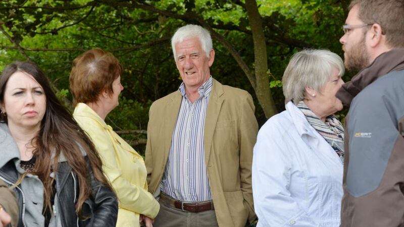 Colm Heaney, brother of Seamus Heaney, with a gathering of people at the Nobel laureate’s grave beside St Mary’s church in Bellaghy, Co Derry, on the first anniversary of the poet’s death. Photograph: Alan Betson