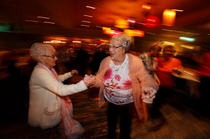 Betty Glass and Georgina Clarke from Cabra up dancing at the Friends of the Elderly Christmas dinner in Dublin. Photograph: Alan Betson