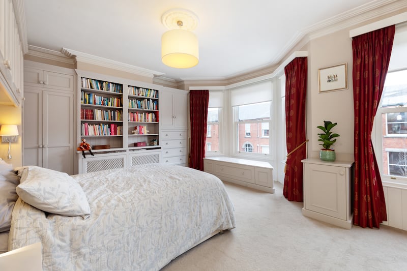 Principal bedroom, with bespoke bookshelf unit designed by Jane Higgins