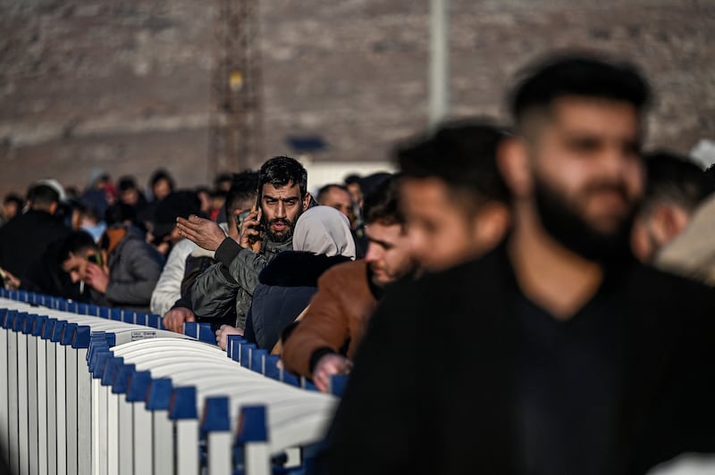 Syrian residents who live in Turkey wait in a queue at Cilvegozu crossborder gate before entering Syria at the Reyhanli district in Hatay. Photograph: Ozan Kose/AFP/Getty Images