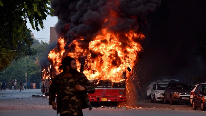 A bus ablaze following a demonstration against the Indian government’s Citizenship Amendment Bill in New Delhi on Sunday. Photograph:  STR/AFP via Getty Images