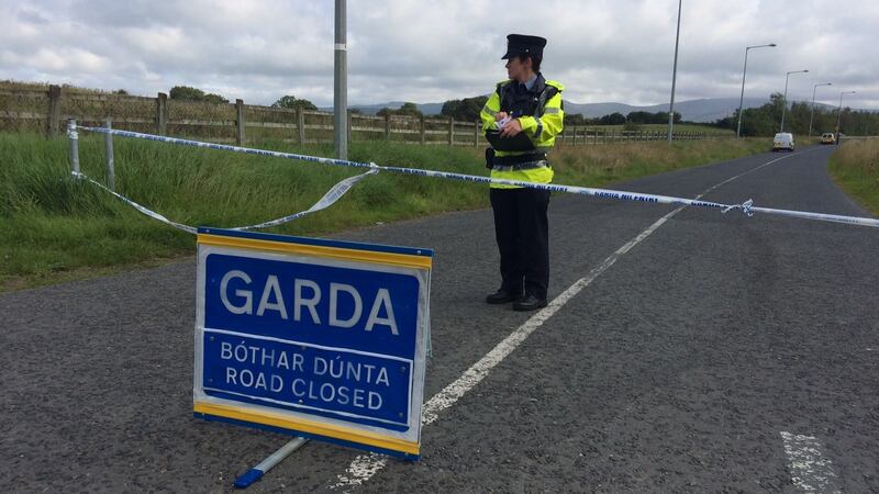 A garda at a barrier in Carnmore, Co Louth, near where the body of a taxi driver was found on Monday morning. Photograph: The Irish Times / Cyril Byrne