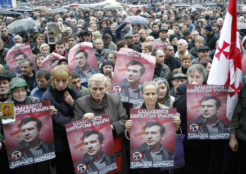 Supporters hold portraits of opposition leader Mikhail Saakashvili during a protest rally outside the Georgian parliament on November 10th. Photograph: Viktor Drachev/AFP via Getty Images